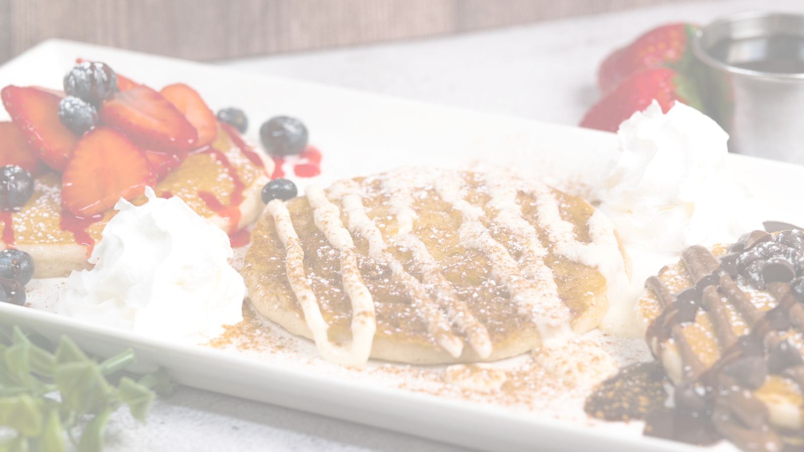 Sweet brunch plates with whipped cream and chocolate